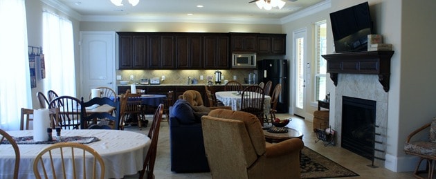Kitchen and dining area with dark cabinetry, fireplace, and dining table