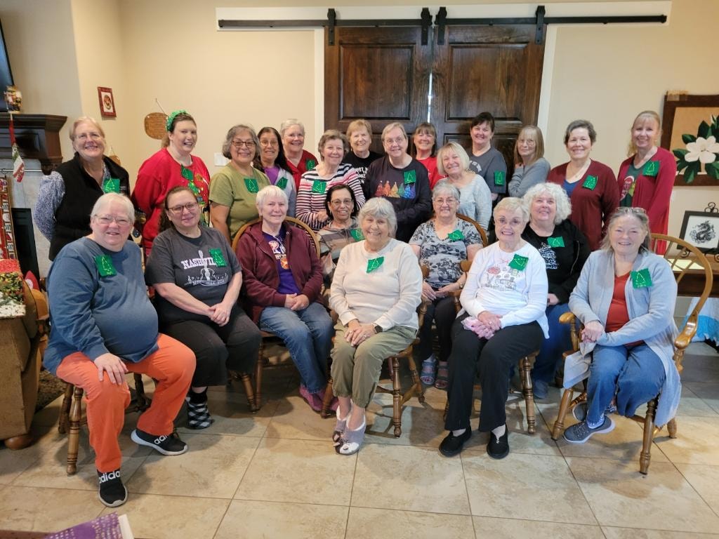 Large group of women gathered in the dining area for a Christmas retreat at Magnolia Manor