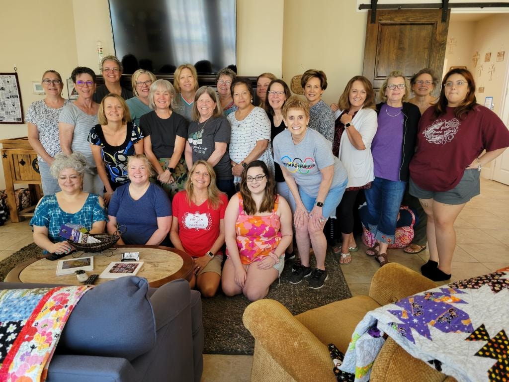 Large group of women gathered in the sitting area for a scrapbooking retreat at Magnolia Manor