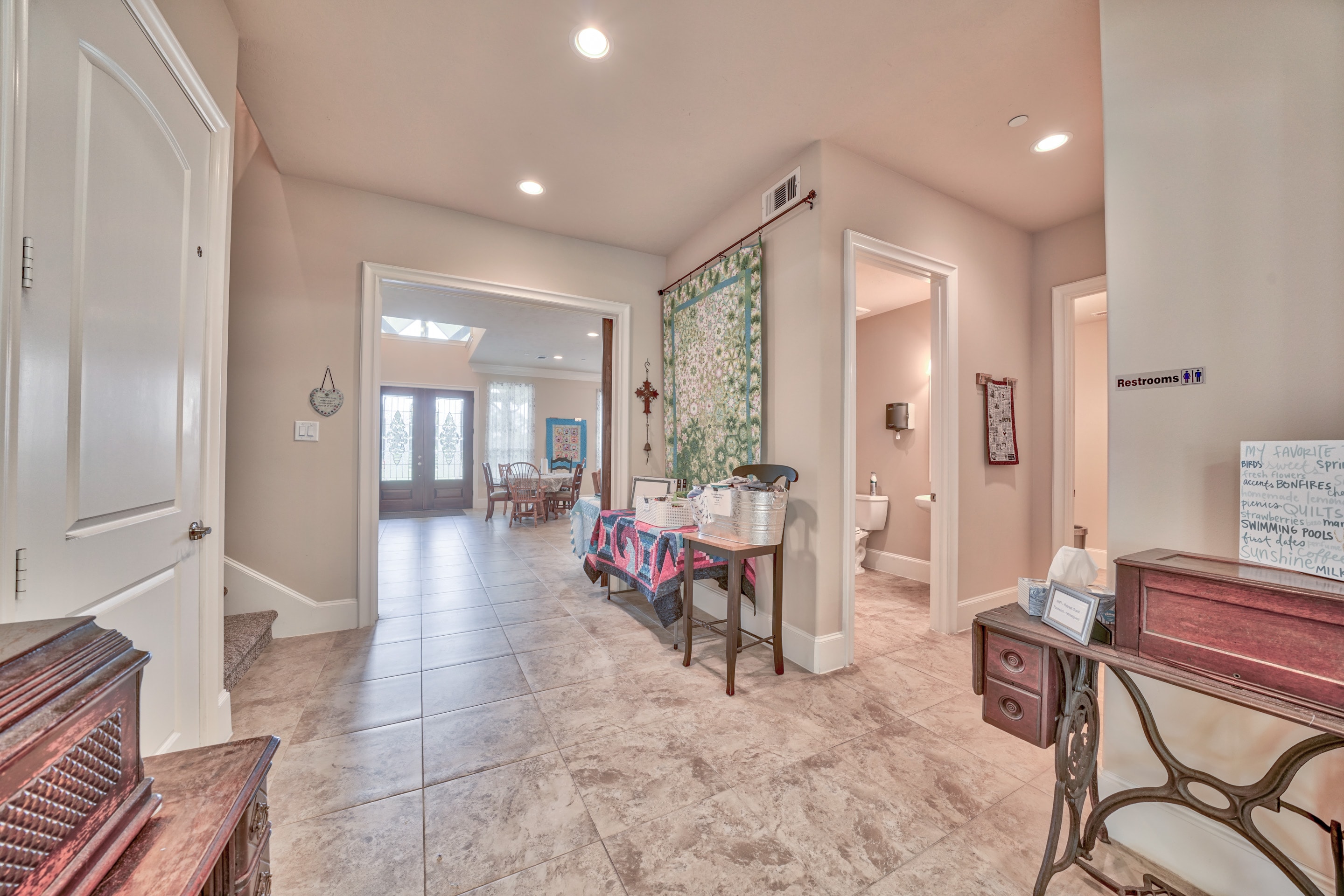 Bright hallway leading to the dining area with tile flooring and open layout